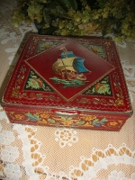 vintage donkerrood koekblik met zeilschip