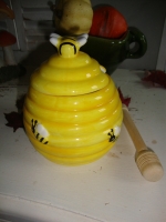 Geel honingpotje met houten lepel